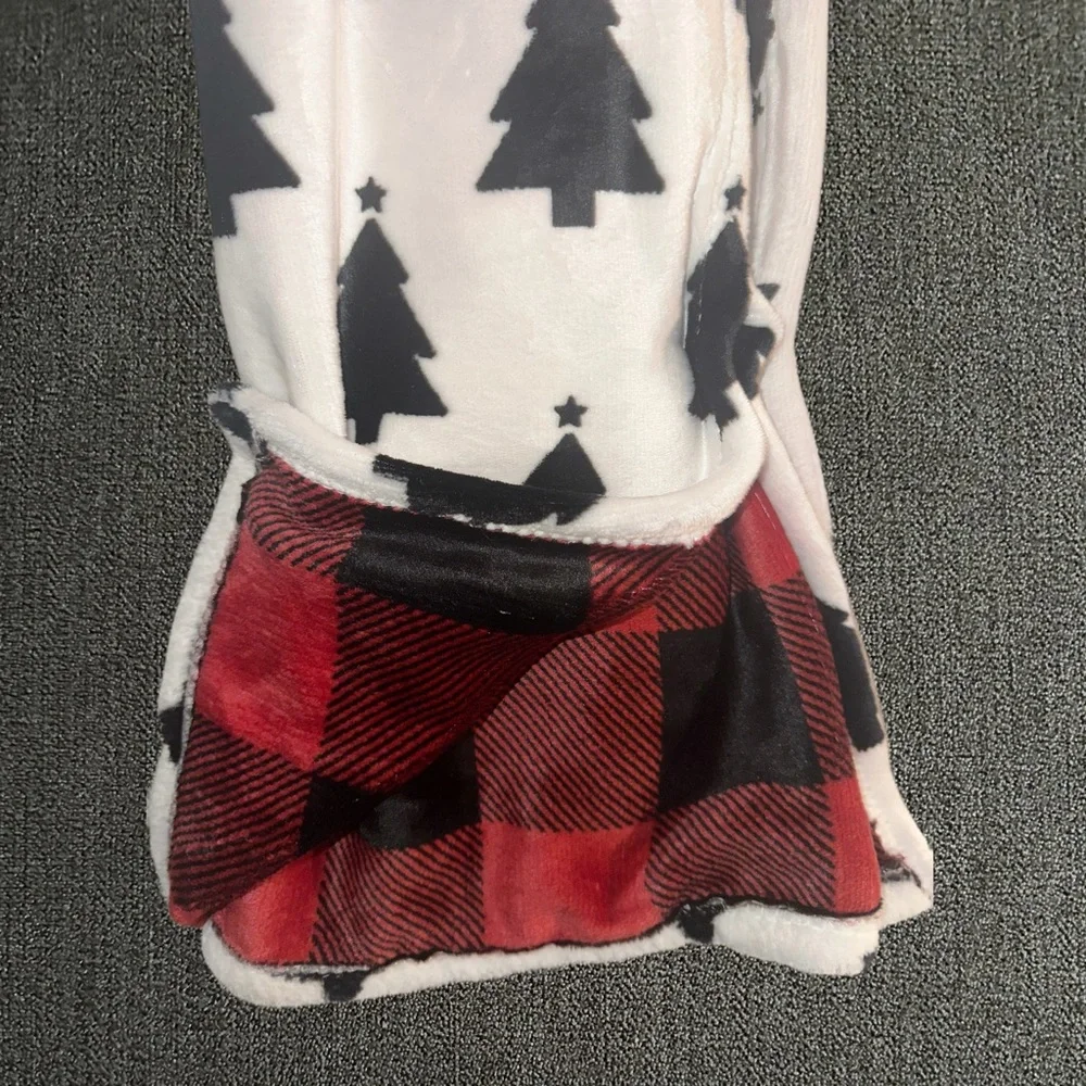 White blanket with black Christmas trees